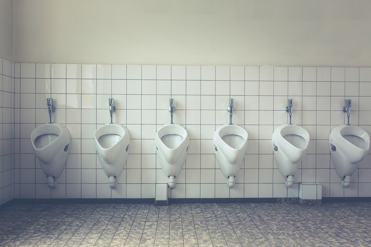 several urinals on the wall